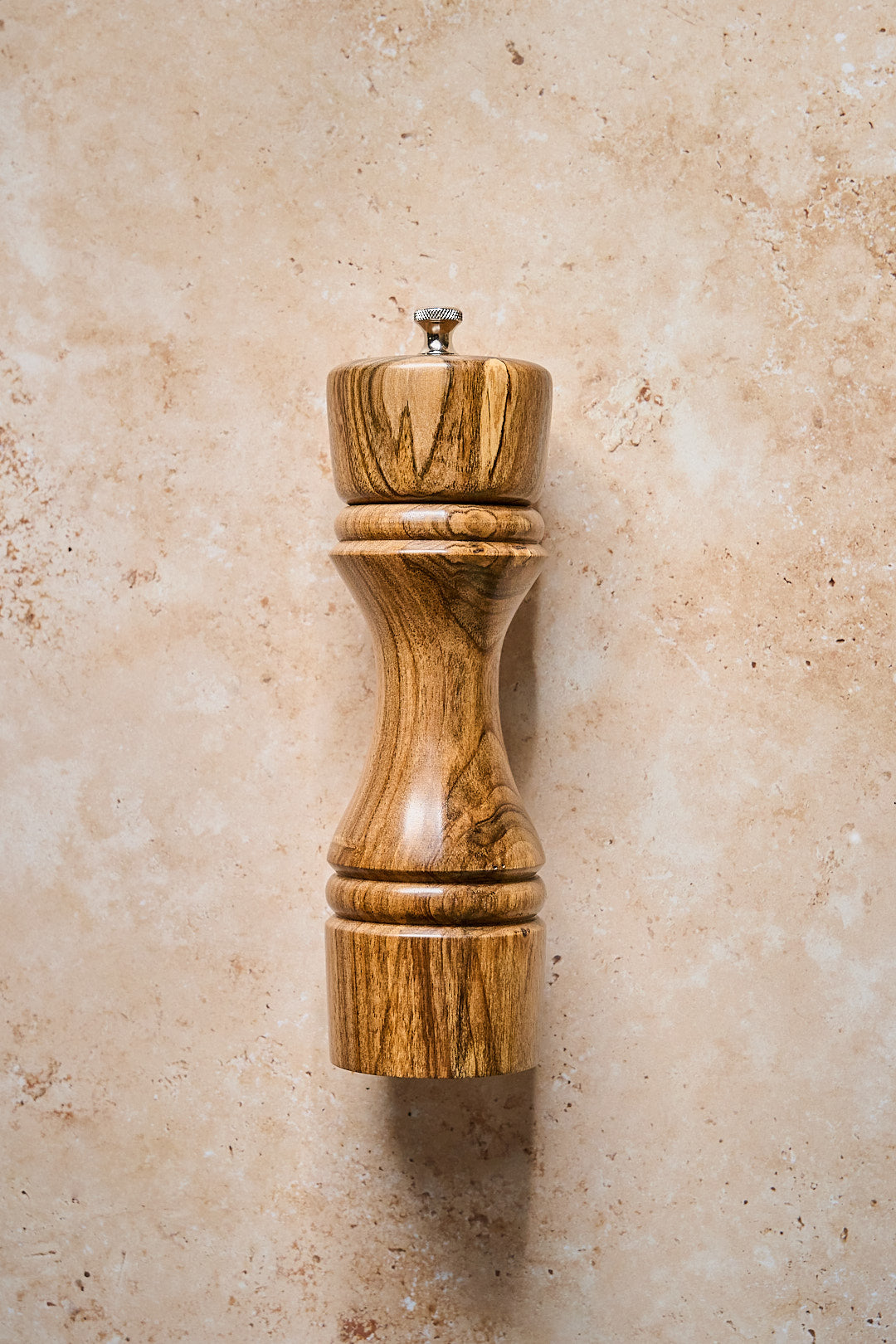 Simple overhead view of handmade walnut pepper grinder