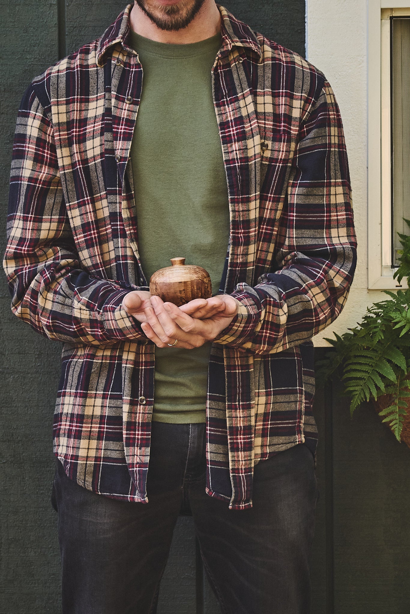 The artist holds his handcrafted maple wood salt cellar in Oregon