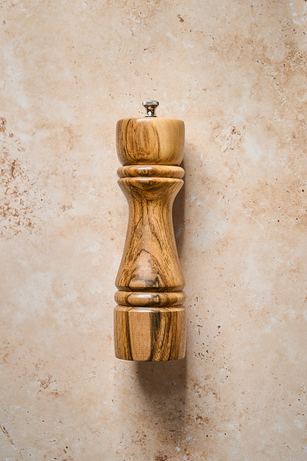 View showing the big pepper grinder resting on a stone counter.