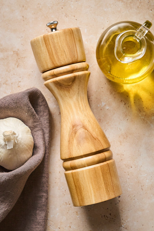 Overhead shot of handmade pepper mill made from light birch wood.