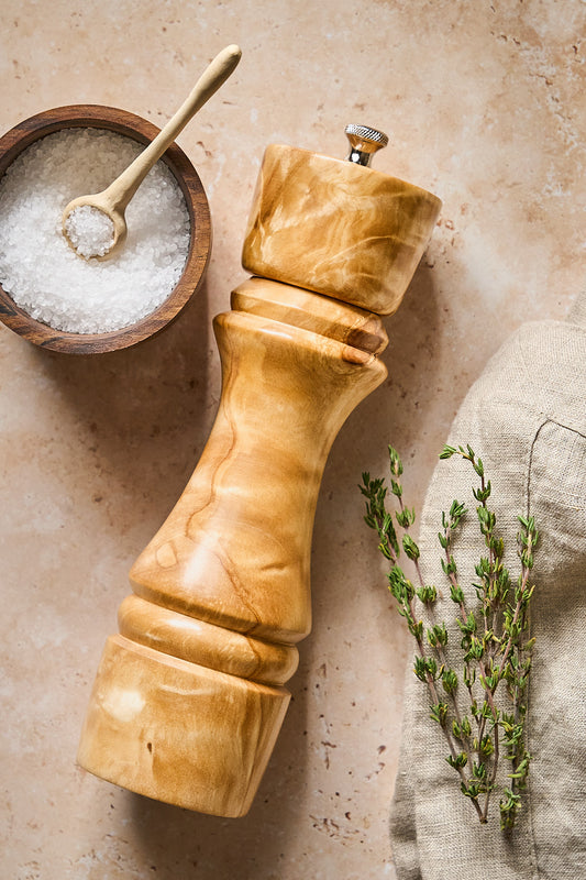 Overhead view of handmade pepper grinder, light birch wood