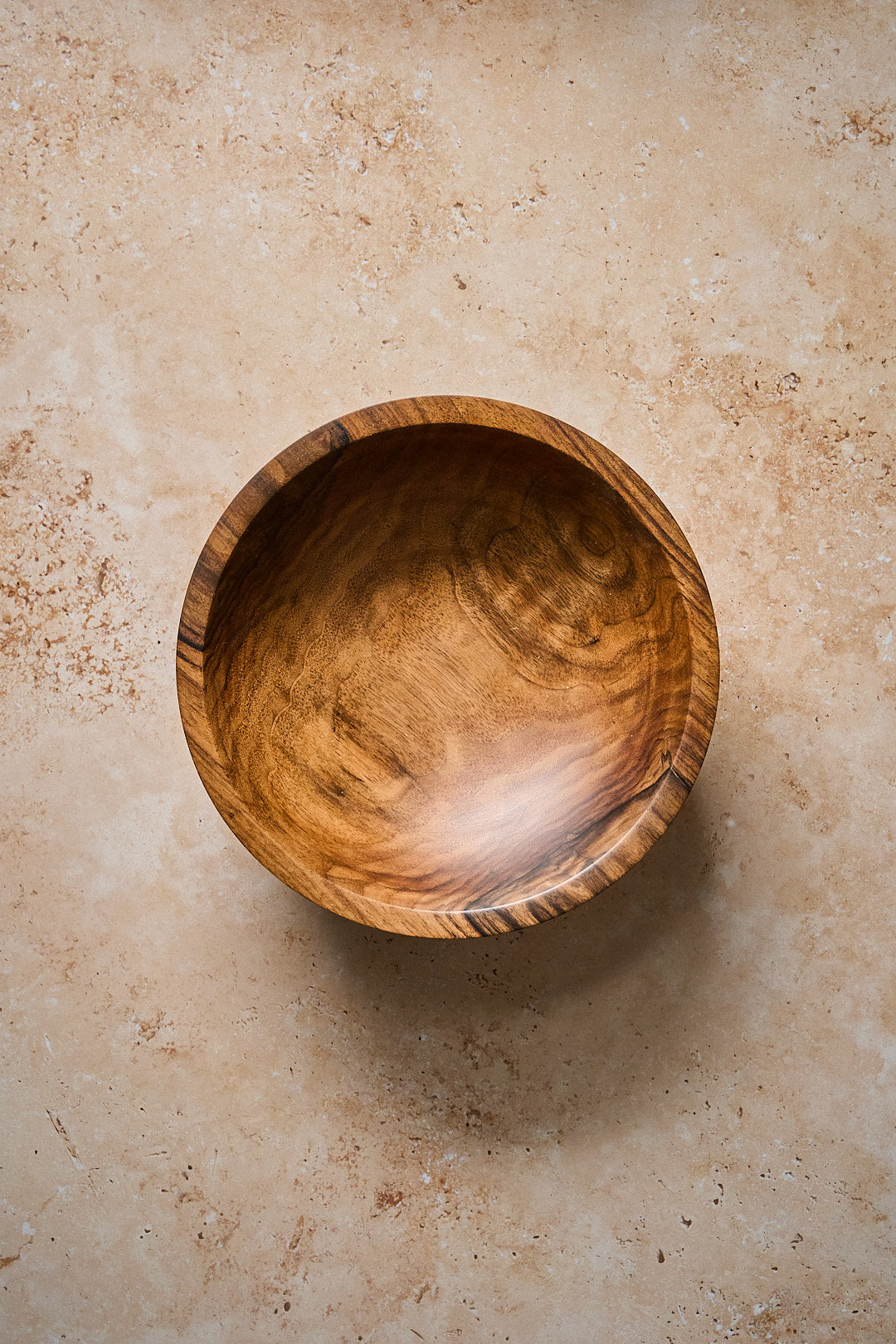 Handmade walnut bowl seen from overhead to see wood grain inside the bowl