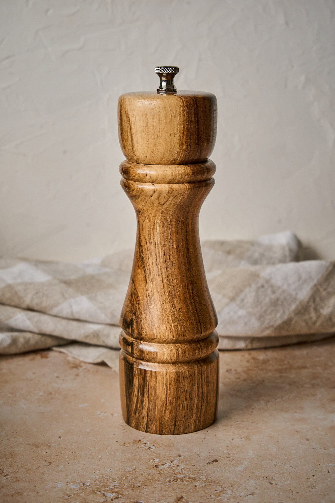 Close up showing the wood grain on the big pepper grinder