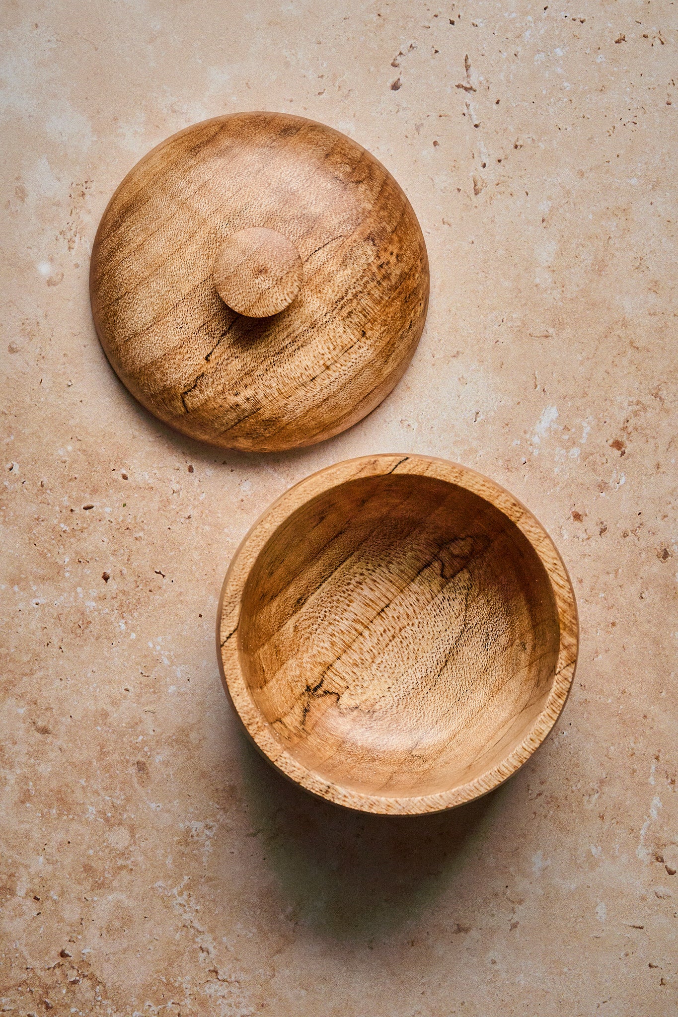 Empty wood salt cellar with the top off showing the interior