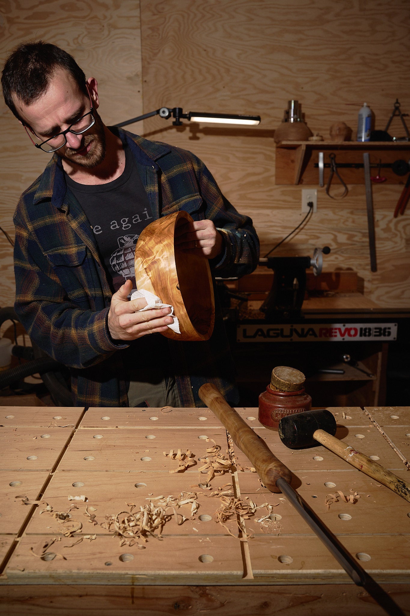 Behind the scenes in the maker's workshop while he polishes the big wood salad bowl