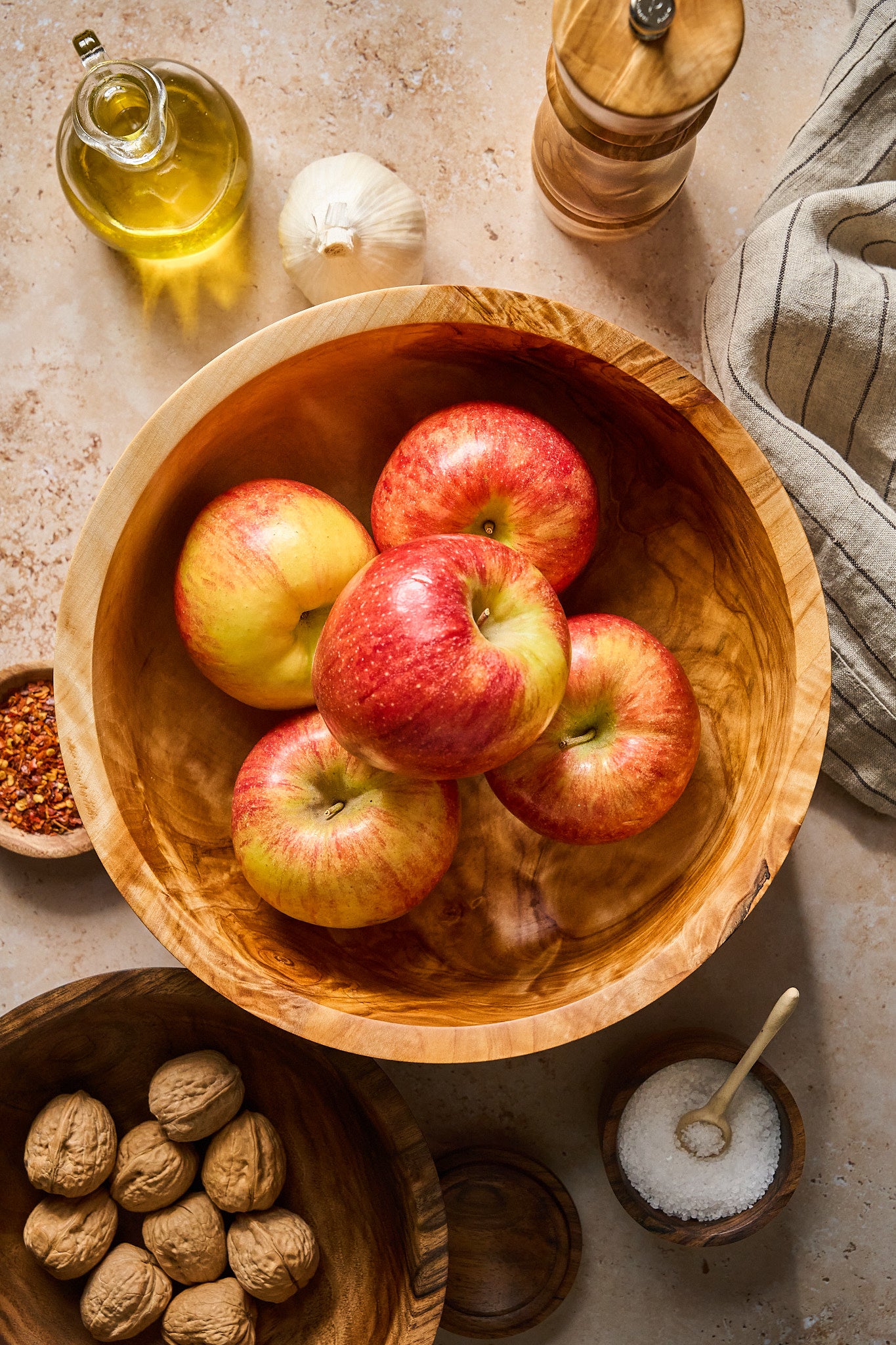 Big wood salad bowl filled with apples in a kitchen scene
